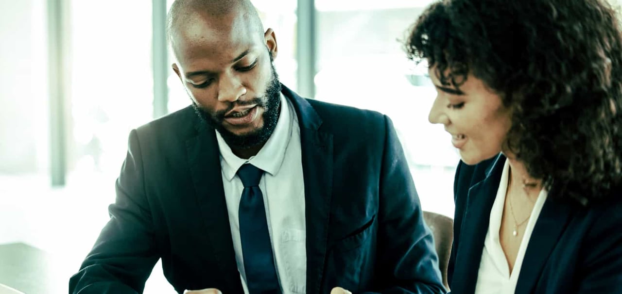 Two professionals looking over a report. 