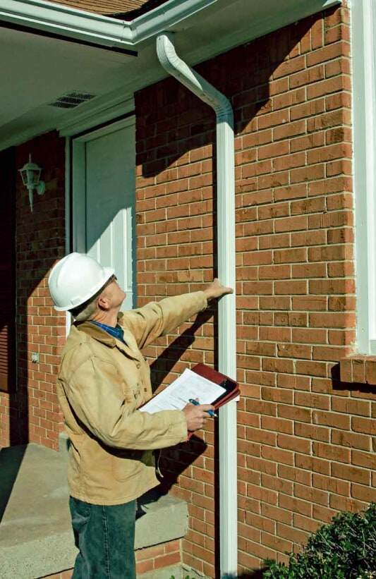home inspector checking gutter